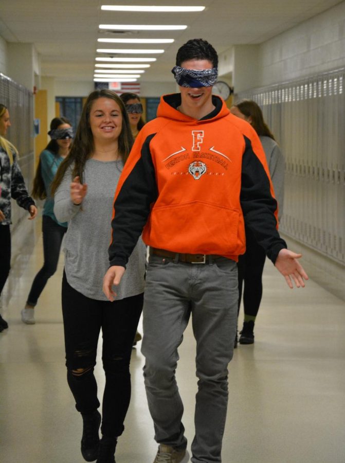 Senior Sophie Crews guides Senior Brandon Bossenburger to the square during a psychology experiment.  Each student was assigned to experience enhanced senses.