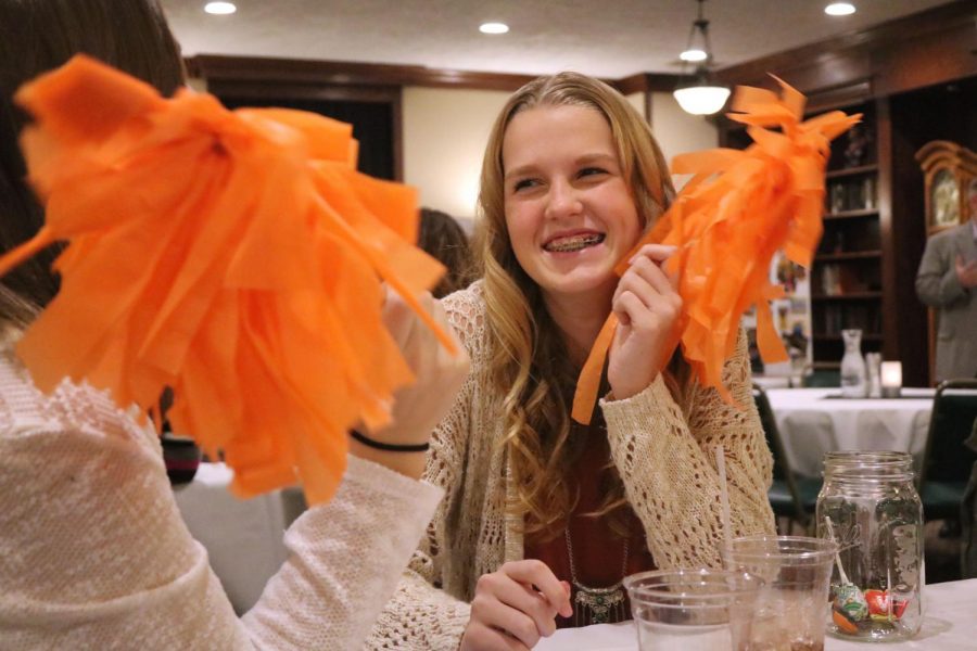 Freshman Korryn Smith has fun with a pom pom at the volleyball banquet hosted to close the season. On November 15th, the volleyball players ate dinner and exchanged gifts, having one last team bonding and celebrating an eventful and thrilling season. 