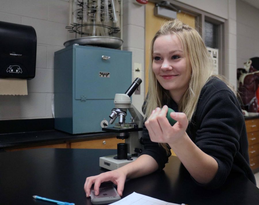 Senior McKenzie Danielson squeezes a stress ball for anatomy teacher, Lisa Stewart, muscle fatigue lab. Danielson and her classmates conducted an experiment on how to lessen the pain in the arms and ways to prevent it. 
