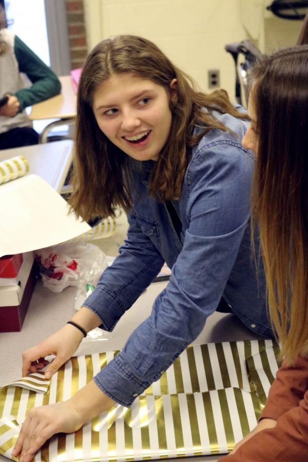 In Srt sophmore Ally Rensi helps wrap gifts that her fellow classmates helped bring in. Many Srt classes helped a child in need by participating in the angel tree.