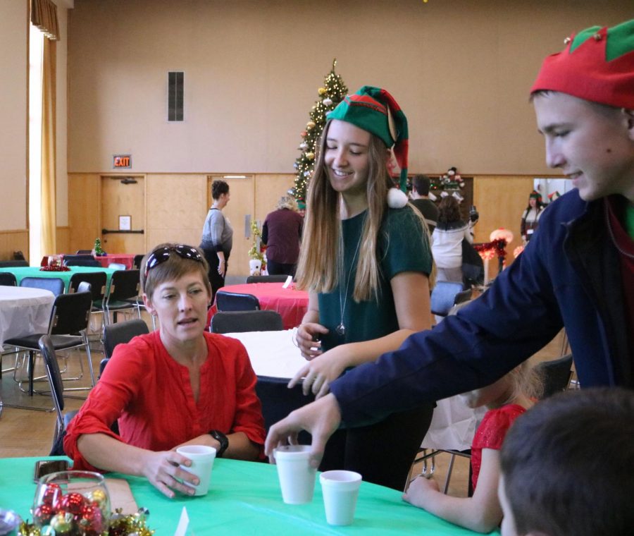 Junior Macie Best shows a woman to her seat for the Breakfast With Santa Jingle Fest celebration. On Dec. 2, parents brought their kids to the Fenton Freedom Center to meet Santa, eat and get into the Christmas spirit.
