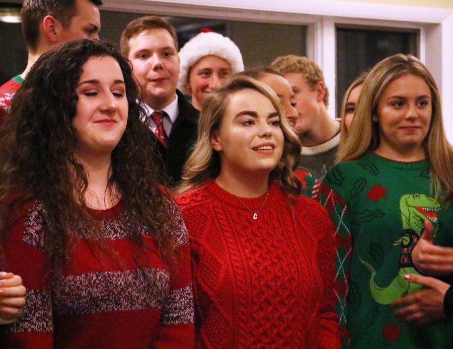 Junior Emily Hayes finishes singing at the Ambassadors Christmas concert. On Dec. 3, members of the Ambassadors met at the Holly Presbyterian Church to perform for friends and family and celebrate the Christmas season.  