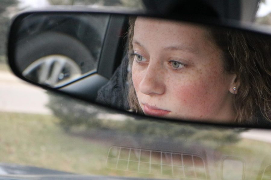 Freshman Lillian Tisch checks her mirror for other cars during drivers training. On Dec. 4, students went on drives with their driving instructors and prepared for the upcoming divers test. 
