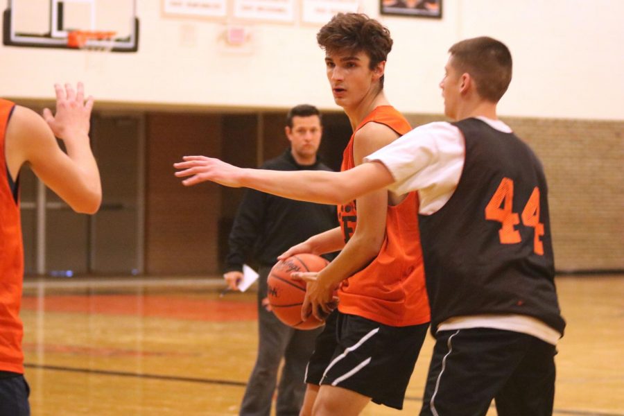 Sophomore Grant Buthardt prepares make a pass to his teammate. On Jan 17, the JV basketball team practiced for an upcoming game against Linden. 
