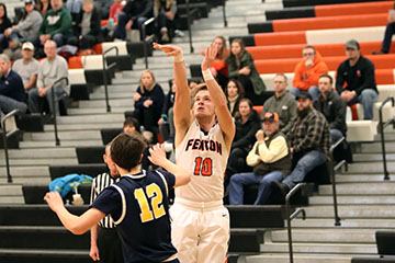 Seizing his opportunity, junior Logan Welch takes his shot at the basket for his team. Fenton varsity team went up against Hartland last Wednesday.