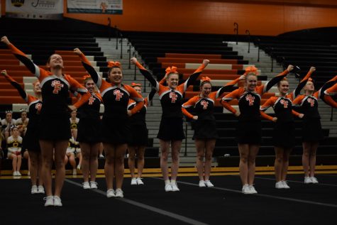 Competing at home on Feb. 16, the girls varsity competitive cheer team participate in their districts meet.