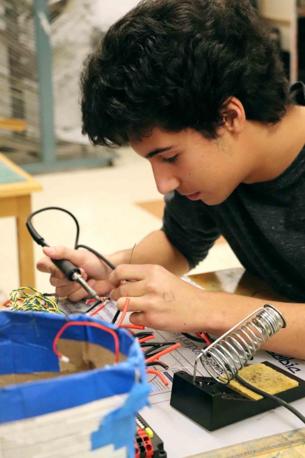Sophomore Vaughn Doyle concentrates on soldering wires connections together for the Robotics Team new robot.The Titanium Tigers first competition will be on Mar. 2. 