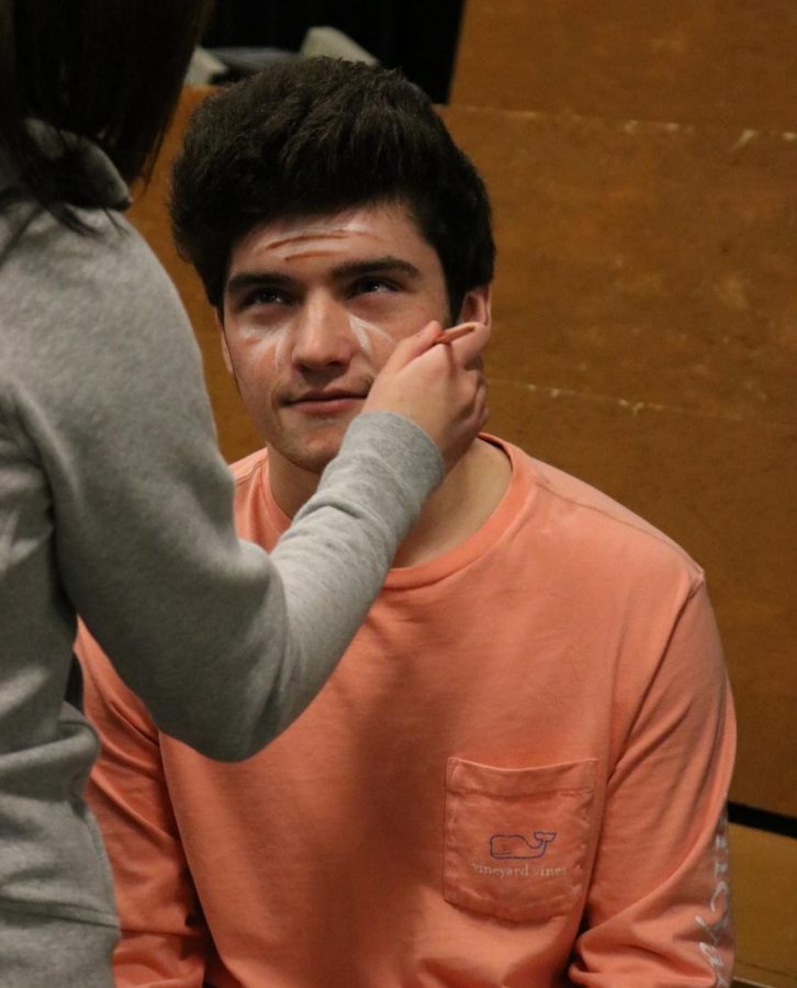 As the brush strokes on his face with the cold, wet paint, senior Josh Maher prepares himself to age 70 years next time he looks in the mirror. The drama department every year learns how to do stage makeup on other students. 