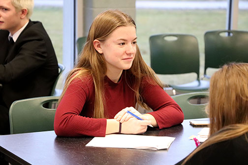 During the IB history speed dating, junior Maddie Hayden talks to several different students about her historical figure. Each student in the class was assigned a person to dress up as and talk about them.
