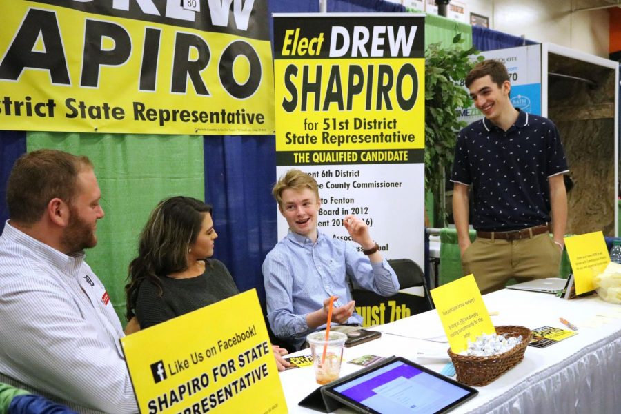 Sophomores Ricky Giltrop and Logan Canada work at the Elect Drew Shapiro booth at the Fenton Expo on March 4. Students helped with Expo and also went to see the booths for different businesses. 