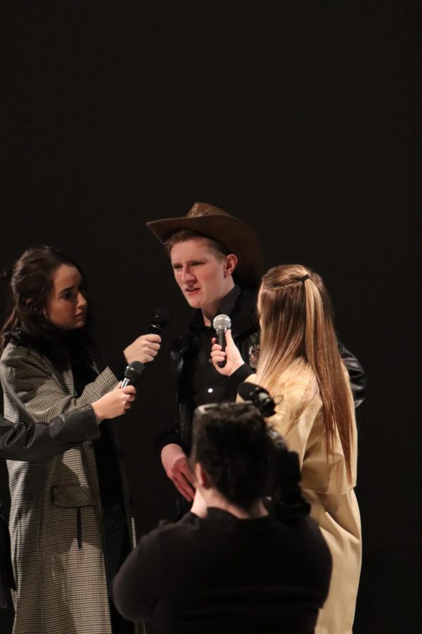 While performing, junior Justice Fredrick acts like he was being interviewed by news. The Laramie Project prepared and worked hard for a weekend of performances with many students who went to watch.  
