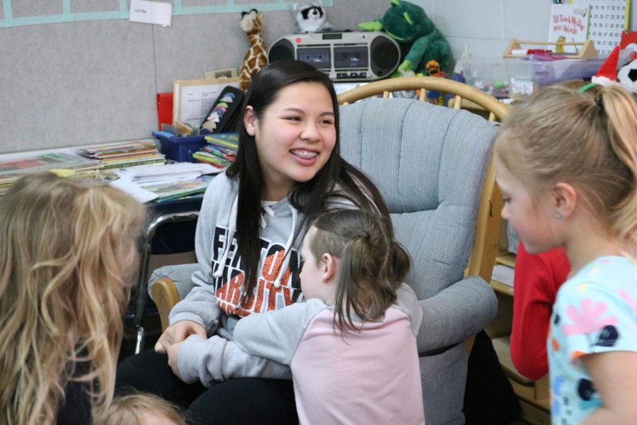 Sophomore Lillian Huynh talks to elementary school students before reading to them. On March 26, Key Club members went to Tomek-Eastern Elementary to read to students for March Reading Month.  
