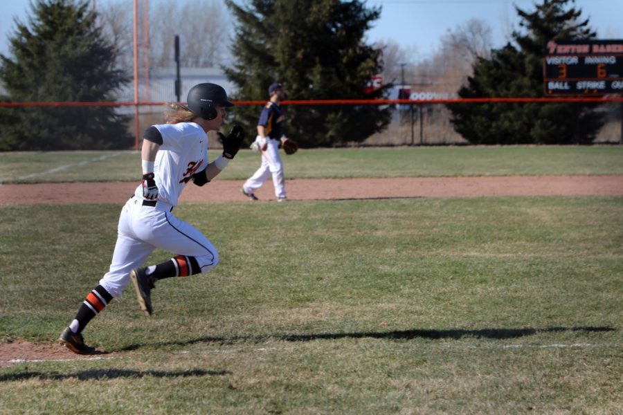 Running to first base, senior Logan Benson plays on Friday night vs Goodrich. The team played hard and won their second game against Goodrich.