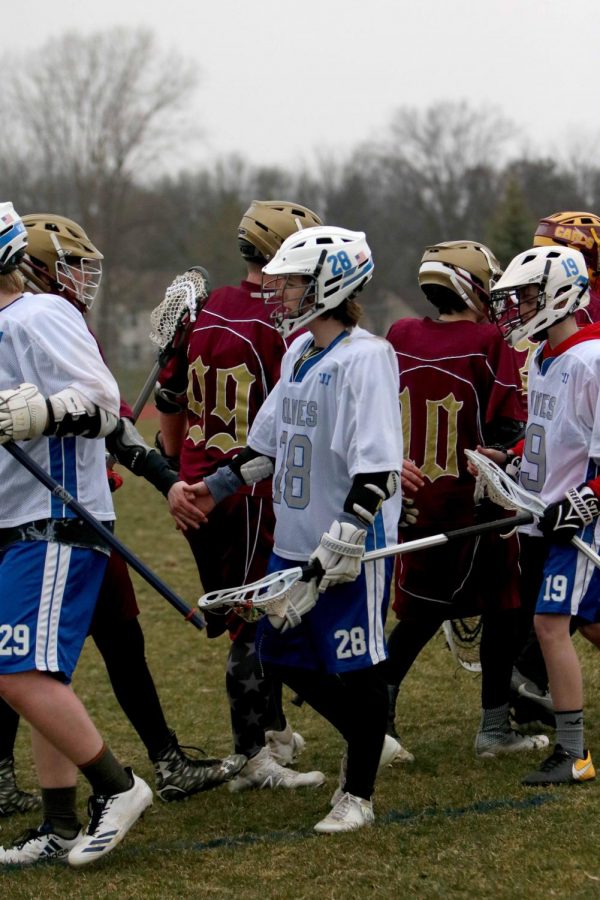 Showing good sportsmanship, sophomore, Nate Ladd shakes hands with the opposing team. The Fenton-Linden boys lacrosse against Davison. (THEY LOST)