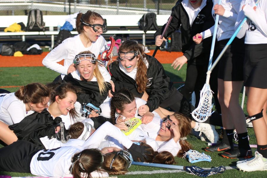 During halftime at the girls varsity lacrosse game, the girls dog pile on top of each other. The girls defeated Ovid-Elsie with a score of 11-0 on April 19.