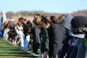 Members of the track team prepare for a practice race. 