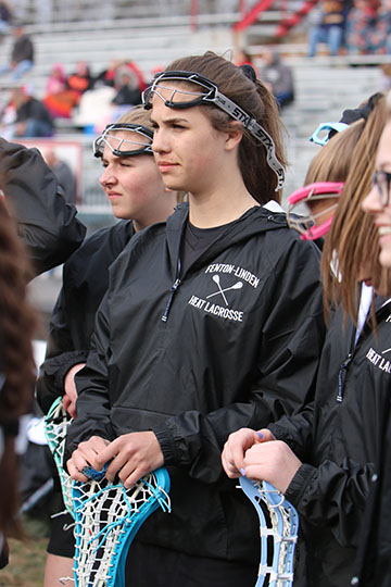 Preparing to begin the game, sophomore Avery Kozak listens to see where she will play. The girls varsity lacrosse team played Adams High School. 