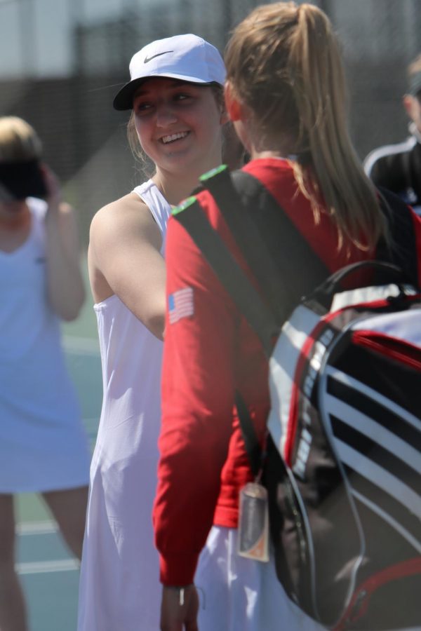 Shaking hands with a Holly High tennis player, sophomore Brooke Kienast is ready to begin her match.  The Fenton girls varsity tennis won 6-3. 