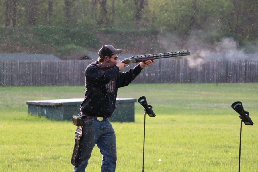 Using an automatic skeet shooter machine, senior Trevor Johnson prepares his shot. The trap team held their weekly practice in preparation for their upcoming meet.