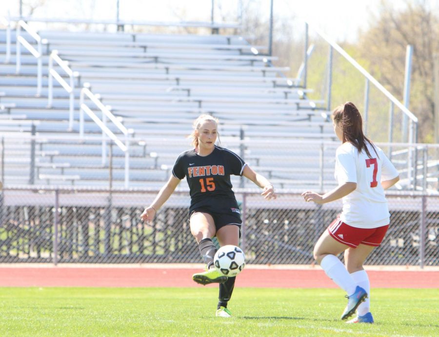 Sophomore Trinity Sawyer passes the ball to another teammate in Holly on May 7. The JV team won 7-1, Varsity won 2-0.