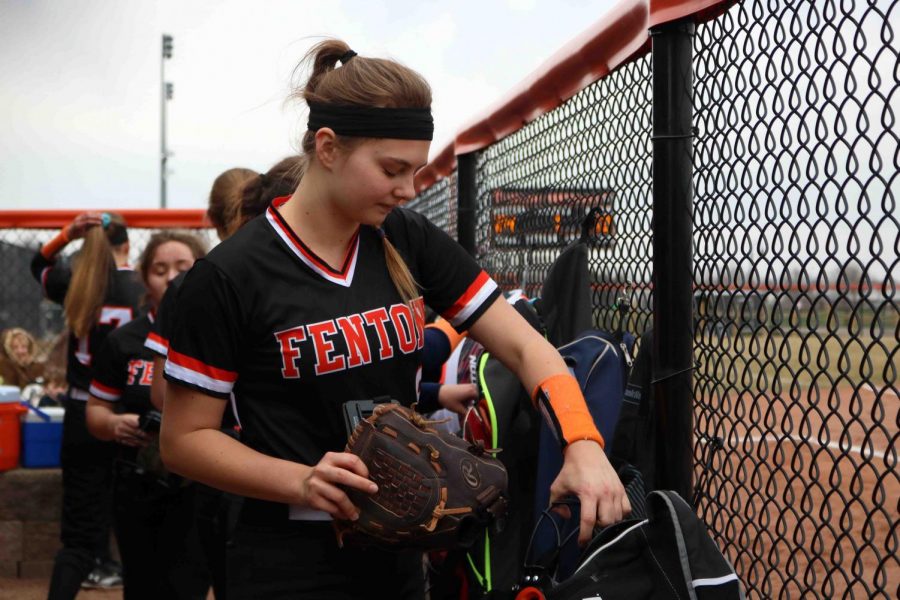 Sophomore Erica Behnfeldt packs her things after the girls JV softball teams game against Flushing. Behnfeldt was officially moved from the junior varsity team to the varsity team on May 1.