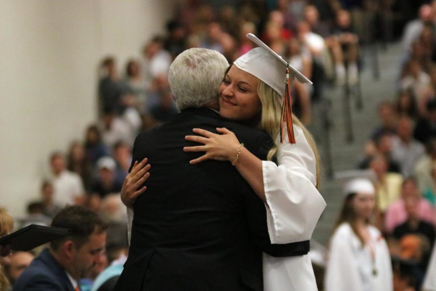 Hugging her family member, graduate Molly Anderson has a big smile on her face. On June 10, Fenton High seniors graduated as the class of 2018. 