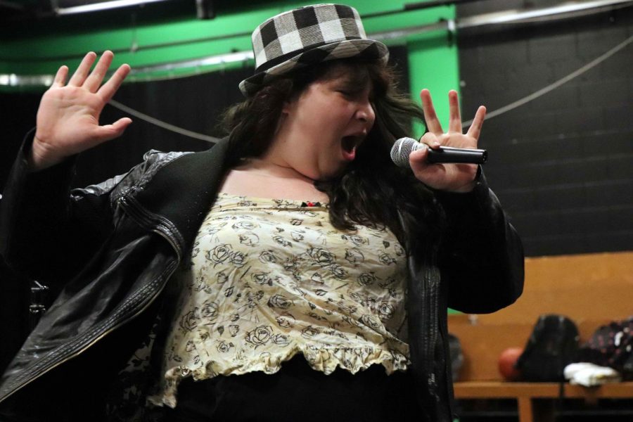 Singing along to Shania Twain, senior Hannah-Marie McDowell performs a skit for her drama class.  The IB Theater class recreated iconic 1990s music videos for their classmates.