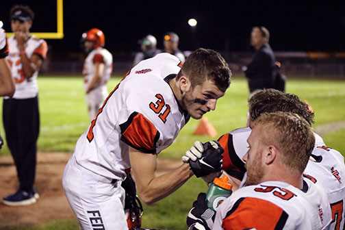 During a timeout, senior Ethan Crawford encourages a teammate. The boys varsity football team beat the Kearsley Hornets on August 31, the team will play next against the Clio Mustangs on September 7.
