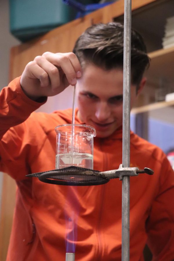Boiling water to make jello, senior Parker Bundy stirs his chemicals and water mixture in his Anatomy class taught by Lisa Stewart. Stewarts classes made poisonous jello to further look into body fat analysis. 