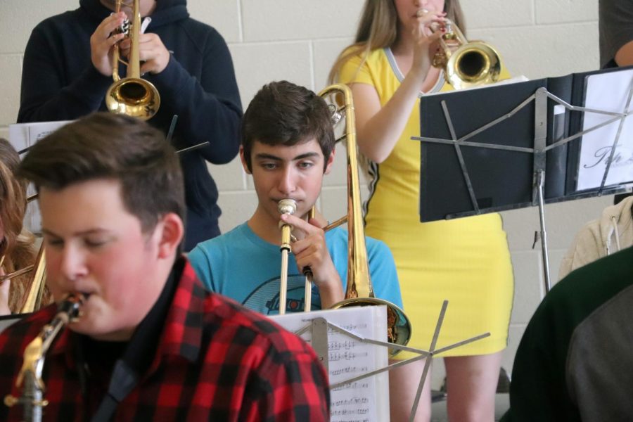 As he performs alongside his Jazz band members, sophomore Aaron Toth plays his trombone during lunch. They played a total of 9 different songs for their classmates.