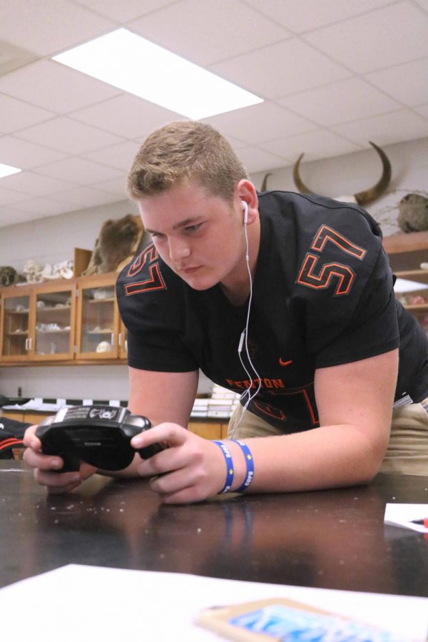 Holding a handheld BIA device that measures body fat sophomore, Josh Thompson stands waiting for his results. Thompson and the rest of his classmates in Mrs. Stewarts class conducted an experiment where they will get to know their body fat. 
