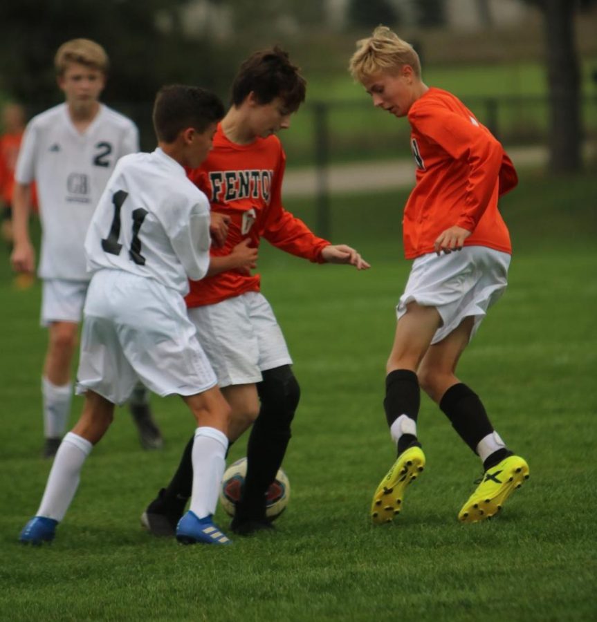 Defending a Grand Blanc opponent, freshman Evan Watts and Chase Coleman team up to get the ball. The Tigers fell to the Bobcats 0-3 in  a tough game against Grand Blanc.