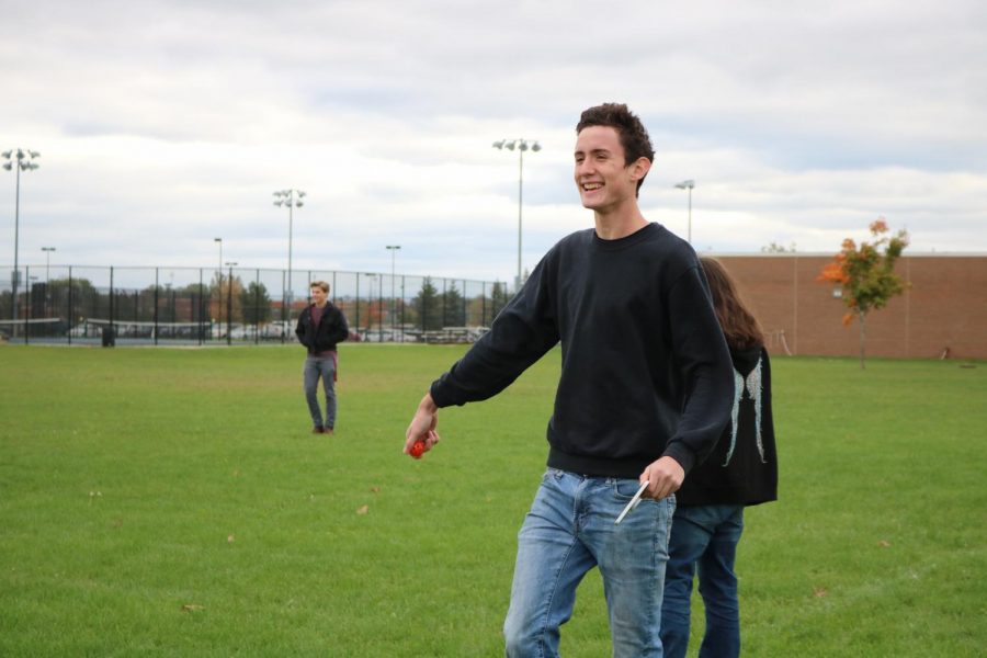 During a physics lab, junior River Taubitz throws a wiffle ball to his lab partner.  The physics classes measured the time and distance each ball is in the air.