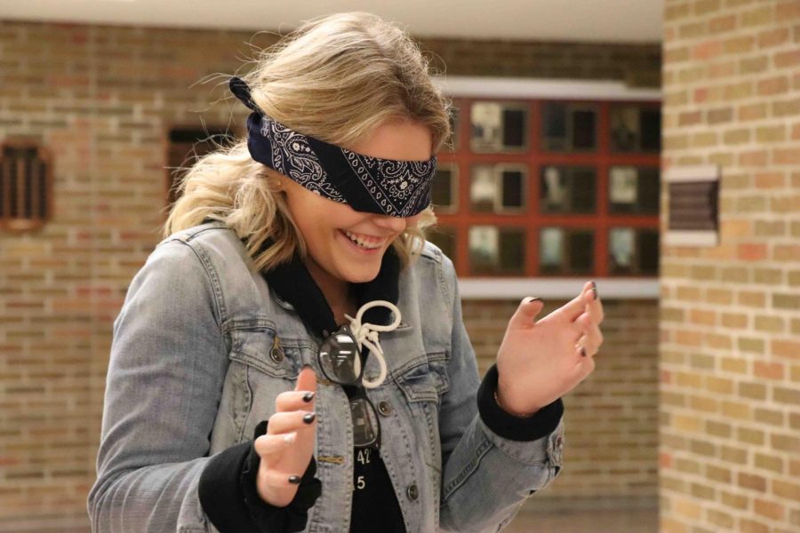Scared of the unknown, senior Grace Hocevar struggles to adapt without her sense of sight. Jill Starrs psychology classes participated in a lab that shows when the sense of sight is removed, other senses are enhanced. 