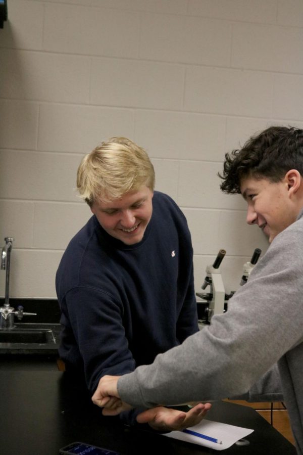While testing out their theory in their Anatomy lab junior Marson Turner uses a roller to roll out classmate junior Elliot Wakehams arm. In Anatomy students were assigned a lab to design a process to help with muscle fatigue in the senario that was given. 
