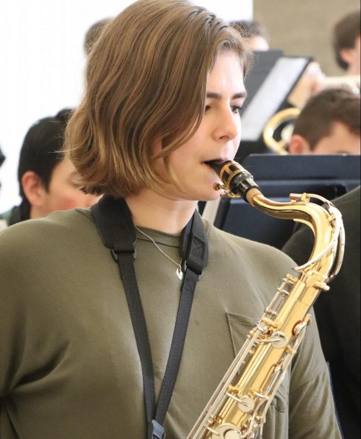 Senior Caitlyn Dailey plays her tenor saxophone. Members of the Jazz Band performed for students during lunch on Dec. 14. 
