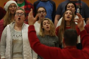 Choir teacher Brad Wright conducts the Bella Voche singers. During SRT on Dec. 20, Jazz band and all choirs performed for students. 