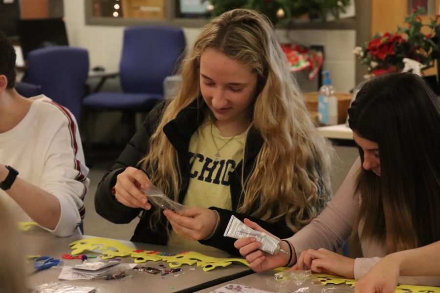 Seniors Lauren Lamb and Rachel Smith decorate crowns with the rest of the yearbook staff. Yearbook staff members decorated crowns on Dec.  3 as a Motivational Monday activity to bring the staff together. 