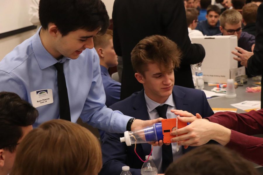 Senior Brady Young and junior Ryan Pearce work with their group. Students attended the annual Boys and Business conference on Dec. 4. 