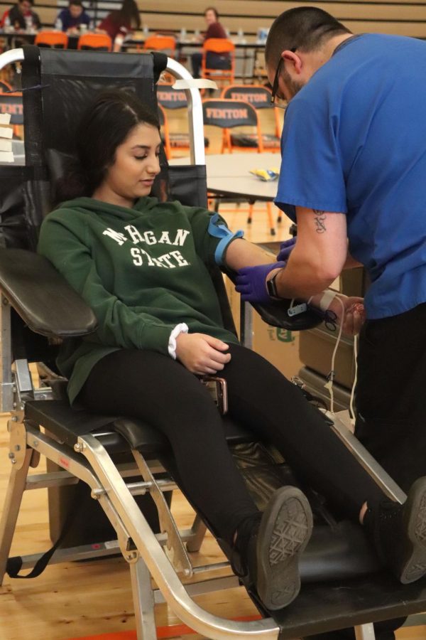 As senior Zena Alshomali takes part in the blood drive, she waits for the Michigan Blood employee to draw her blood. On Jan. 10 the Michigan Blood hosted the winter blood company to hosted the winter blood drive at FHS.