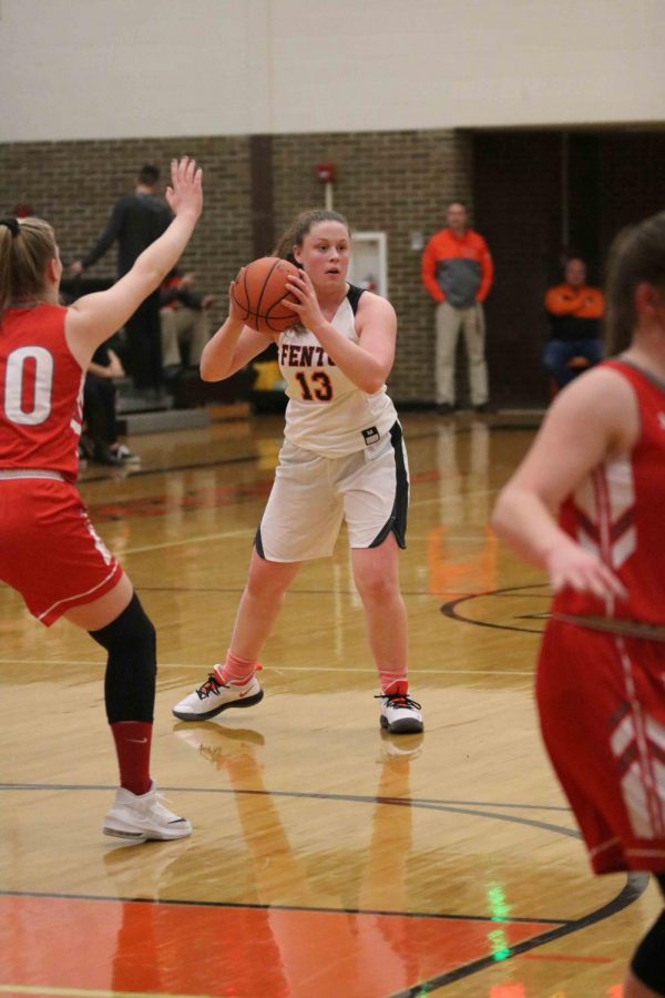 On her feet, sophomore Kyla Lynch gets ready to pass the ball. The girls varsity basketball team played before the boys varsity basketball team on Friday, Jan. 4.
