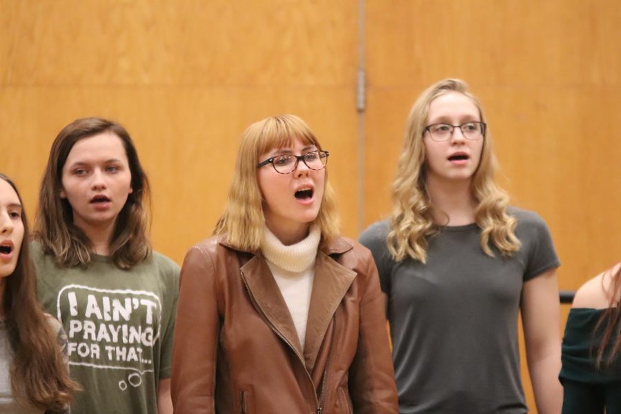 Singing in front of the whole school, Senior Megan Mallard enjoys her last SRT holiday concert. Every year, the choirs and band perform during SRT. This year the concert was on the last day of school before Christmas break, Dec. 20. 