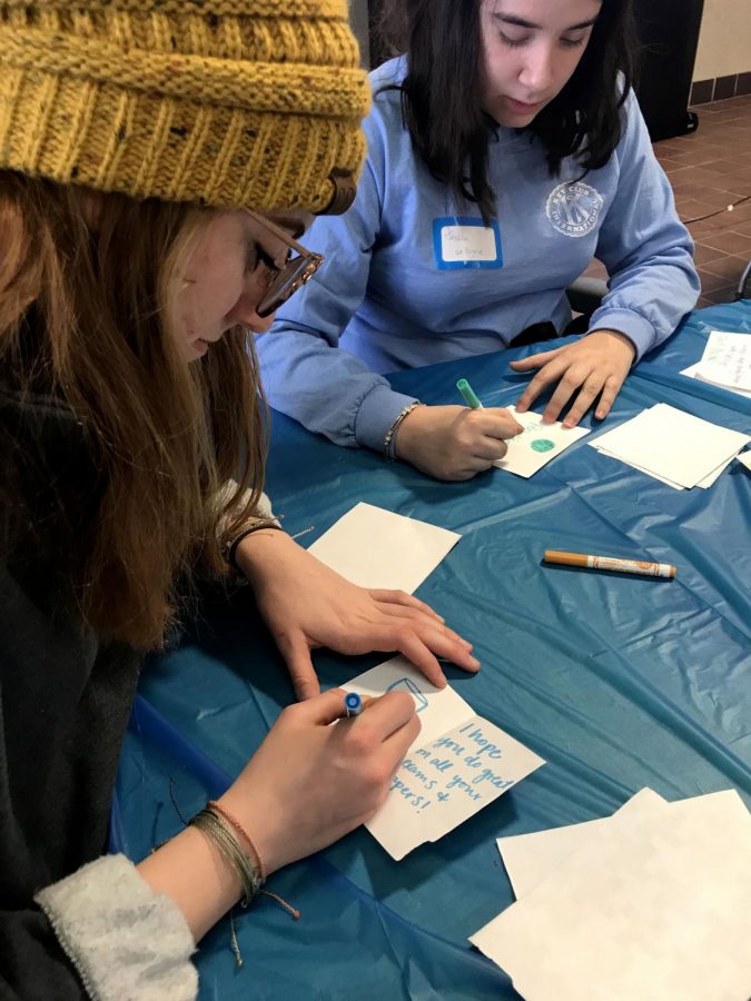 Key Clubs from multiple schools make notes with positive messages for college students and pass them out. Senior Jessica De Boyrie writes Marvel quotes on her notes.