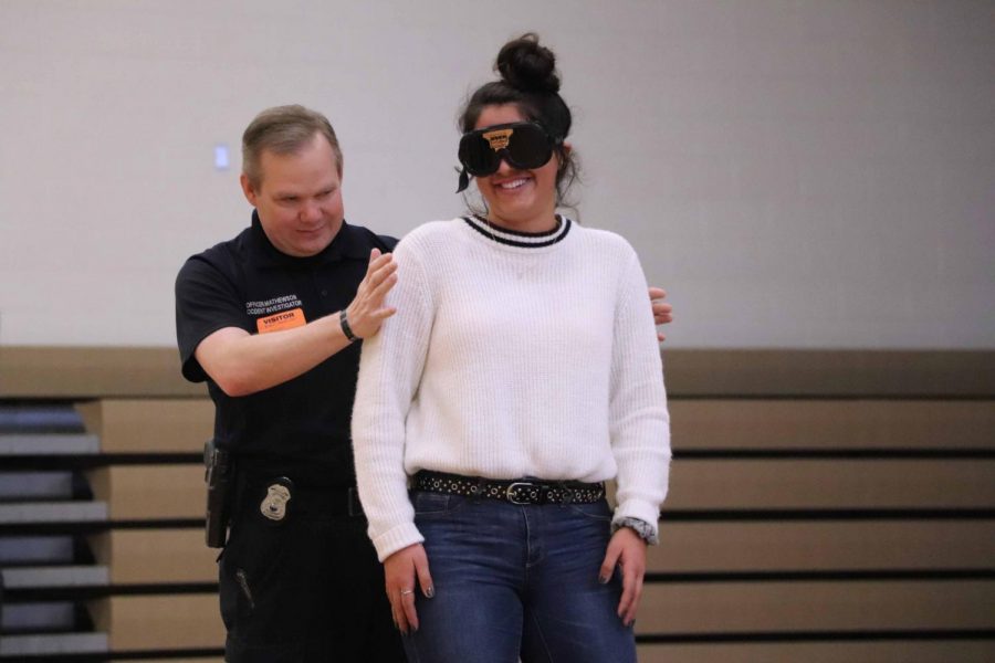 In Mr. Sullivans forensic class, the students are giving a pair of goggle to see what it drinking alcohol will do to their visions. Senior Delaney Miesh volunteered during the experiment. 