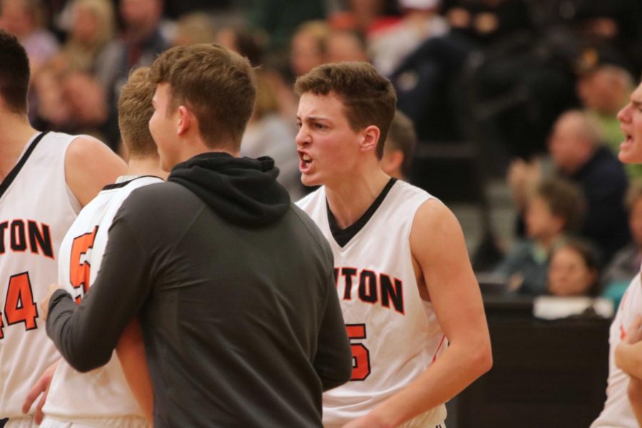 After calling a timeout, junior Lucas Claborn cheers for his teammate, junior Alec Kussro.  The boys varsity basketball team lost to Linden on Feb. 22 with a score of 73-52.