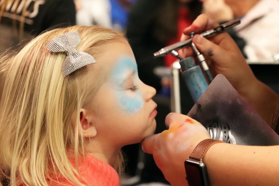 While attending the Fenton Expo with her mother Kristin McDowell, Sinéad McDowell gets face paint at the Dr. Wax Orthodontics booth. The Fenton Expo had many businesses in the Fenton High School with many activities for kids like face painting.
