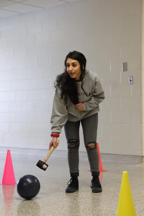 Looking down the hallway, senior Zena Ashomali tries to strategize how to get her bowling ball through the no touch zone. Colleen Rischs physics class was bowling to learn about motion and kinetic energy. 