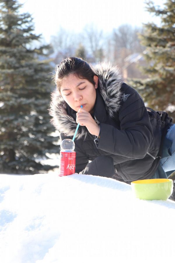 Junior Lily Sanches uses a soap mixture to help create the perfect bubble. In Pam Bunkas Desktop Publishing and Photography class, students went outside to try to create a bubble that had ice crystals forming inside of it. 