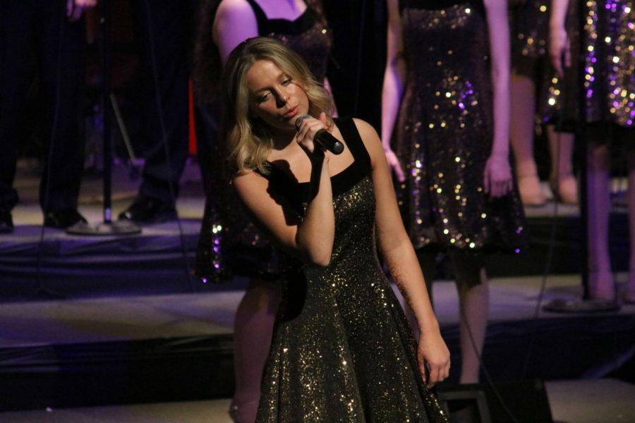 Performing in front of her last class as an ambassador, senior Alex Marsee sings her solo. The ambassadors senior concert took place on May 11 in the Rupy Zima Auditorium.