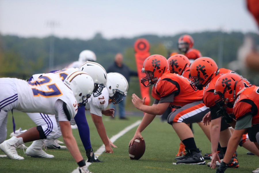 While standing ready and center, freshman John Dixner prepares to set a play in motion. On Sept. 12, the freshman football team played De La Salle Collegiate for the third game of their season.
